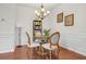 Elegant dining room with a round table, wainscoting, and a stylish chandelier at 5711 Keys Way, Lithonia, GA 30058