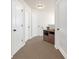 Neutral hallway with three white doors and carpet at 5711 Keys Way, Lithonia, GA 30058