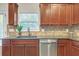 Granite countertops and stainless steel appliances in this kitchen, complemented by ample wooden cabinetry at 5711 Keys Way, Lithonia, GA 30058