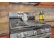 Detailed view of a stainless steel gas range with a tile backsplash and granite countertops at 5711 Keys Way, Lithonia, GA 30058