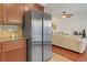 Modern kitchen featuring a stainless steel refrigerator and wooden cabinets, offering ample storage and style at 5711 Keys Way, Lithonia, GA 30058