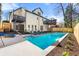 Inviting backyard with a swimming pool, lounge chairs, and a multi-story home with balconies at 1230 Newbridge Ne Trce, Brookhaven, GA 30319