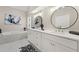 Bright Primary bathroom with a double vanity, soaking tub, modern mirrors, and stylish decor at 1230 Newbridge Ne Trce, Brookhaven, GA 30319