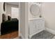 Well-lit bathroom featuring a modern vanity with a marble countertop and a round mirror at 1230 Newbridge Ne Trce, Brookhaven, GA 30319