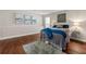 Comfortable bedroom with hardwood floors, neutral paint, and decoratively framed modern artwork at 1230 Newbridge Ne Trce, Brookhaven, GA 30319