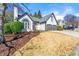 Beautiful home featuring a manicured lawn, complemented by mature trees, stucco facade, and a two-car garage at 1230 Newbridge Ne Trce, Brookhaven, GA 30319