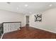 Open hallway with dark wood floors, wrought iron railing and recessed lighting at 1230 Newbridge Ne Trce, Brookhaven, GA 30319