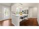 Bright kitchen with white cabinetry, stainless steel appliances, a breakfast bar, and access to the deck at 1230 Newbridge Ne Trce, Brookhaven, GA 30319
