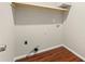 A basic laundry room featuring washer and dryer hookups, overhead storage, and neutral-toned walls at 1230 Newbridge Ne Trce, Brookhaven, GA 30319