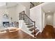 Bright living room with fireplace, hardwood floors, staircase with iron railing, and high ceilings for an airy feel at 1230 Newbridge Ne Trce, Brookhaven, GA 30319