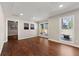 Spacious living space with hardwood floors, large windows with backyard views, and modern decor at 1230 Newbridge Ne Trce, Brookhaven, GA 30319