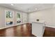 Bright living space with hardwood floors, three windows overlooking a pool, and a center island at 1230 Newbridge Ne Trce, Brookhaven, GA 30319