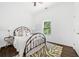 Cozy bedroom features a metal frame bed, wood floors, and a bright, sunny window at 1321 Bridges Sw Ave, Atlanta, GA 30310