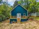 Backyard view of a charming home with a teal exterior, a new deck, and freshly laid stairs at 1321 Bridges Sw Ave, Atlanta, GA 30310