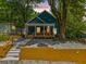 Charming blue home featuring a welcoming front porch and a beautifully landscaped front yard at 1321 Bridges Sw Ave, Atlanta, GA 30310