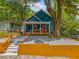 Charming blue home featuring a welcoming front porch and a beautifully landscaped front yard at 1321 Bridges Sw Ave, Atlanta, GA 30310