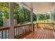 Inviting covered front porch with wood flooring and railing, perfect for enjoying the outdoors at 1321 Bridges Sw Ave, Atlanta, GA 30310