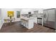 Modern kitchen with white cabinets, stainless steel appliances, and a granite island with bar stools at 1321 Bridges Sw Ave, Atlanta, GA 30310