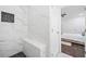 Elegant shower with marble tile walls, a built-in bench, and modern fixtures at 1321 Bridges Sw Ave, Atlanta, GA 30310