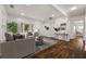 Bright living room featuring hardwood floors, a bay window, and stylish decor at 2584 Oldknow Sw Dr, Atlanta, GA 30318