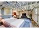 Basement bedroom with exposed ceiling, concrete walls, shelves, and TV at 32 Hillcrest Se Dr, Austell, GA 30168