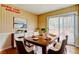 Dining room with striped wallpaper, a large wooden table set for a meal, and a sliding door to an outdoor deck at 32 Hillcrest Se Dr, Austell, GA 30168