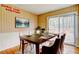 Dining room with striped wallpaper, a large wooden table set for a meal, and a sliding door to an outdoor deck at 32 Hillcrest Se Dr, Austell, GA 30168