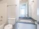 Bright bathroom features a modern vanity with gray countertop and neutral-colored walls at 2149 Shoals Way, Decatur, GA 30034