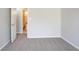 Carpeted bedroom with view into bathroom, featuring neutral-colored walls at 2149 Shoals Way, Decatur, GA 30034