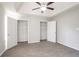 Spacious bedroom with closets, carpet, tray ceiling, and ceiling fan at 2149 Shoals Way, Decatur, GA 30034