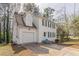 A white, two-story house with black shutters, an attached garage, and a concrete driveway at 2149 Shoals Way, Decatur, GA 30034