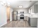 Modern kitchen with stainless steel appliances, white subway tile backsplash, and gray cabinetry at 2149 Shoals Way, Decatur, GA 30034