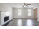 A cozy living room featuring a fireplace, neutral walls, wood-look flooring, and bright natural light at 2149 Shoals Way, Decatur, GA 30034