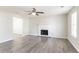 Bright living room featuring a fireplace, ceiling fan, wood-look floors, and plenty of natural light at 2149 Shoals Way, Decatur, GA 30034