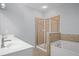 Bathroom with a tiled shower, a soaking tub and a double sink at 2393 Strand Ave, Lawrenceville, GA 30043