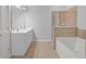 Bathroom with a bathtub, shower and double vanity at 2393 Strand Ave, Lawrenceville, GA 30043