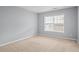 Bedroom with a large window and carpet floors at 2393 Strand Ave, Lawrenceville, GA 30043