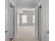View into a bedroom with tray ceilings, carpet, and large windows at 2393 Strand Ave, Lawrenceville, GA 30043