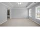 Spacious primary bedroom with tray ceilings and lots of natural light from multiple windows at 2393 Strand Ave, Lawrenceville, GA 30043