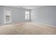 Large bedroom with carpeted floors and natural light entering through a large window at 2393 Strand Ave, Lawrenceville, GA 30043