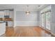 Dining area with hardwood floors and a modern chandelier near the kitchen at 2393 Strand Ave, Lawrenceville, GA 30043