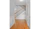 Inviting entryway with hardwood floors, white trim, and staircase with wood railing at 2393 Strand Ave, Lawrenceville, GA 30043