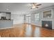 Open-concept room with hardwood flooring, fireplace, and kitchen view at 2393 Strand Ave, Lawrenceville, GA 30043