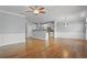 Open-concept living space with hardwood floors, leading to a modern kitchen at 2393 Strand Ave, Lawrenceville, GA 30043