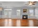 Spacious living area featuring hardwood floors, fireplace and ample natural light at 2393 Strand Ave, Lawrenceville, GA 30043