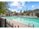 Community pool with lounge chairs and tennis court in the background at 2393 Strand Ave, Lawrenceville, GA 30043