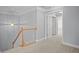 Carpeted staircase leading to an upper level, illuminated by a hanging pendant light at 2393 Strand Ave, Lawrenceville, GA 30043