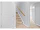 Carpeted staircase with a wooden handrail leads to an upper or lower level at 2393 Strand Ave, Lawrenceville, GA 30043