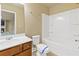 Bathroom features tub, toilet, and vanity with marble countertop and wood cabinets at 3070 Staglin Dr, Powder Springs, GA 30127