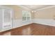 Bright dining room featuring hardwood floors, wainscoting detail, and natural light at 3070 Staglin Dr, Powder Springs, GA 30127